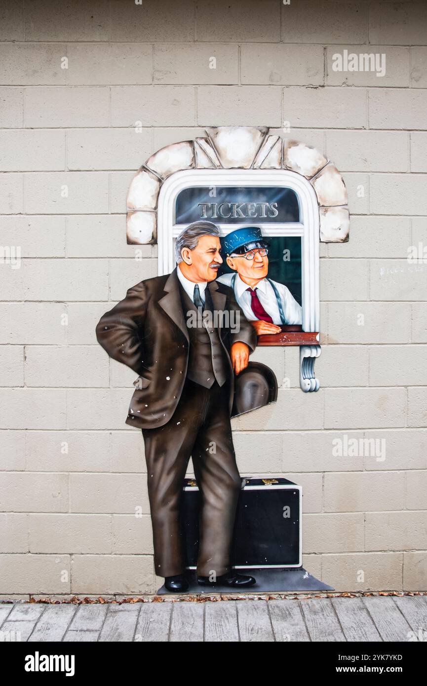 Historic mural purchasing train ticket at Windsor Sculpture Garden park in Windsor, Ontario, Canada Stock Photo