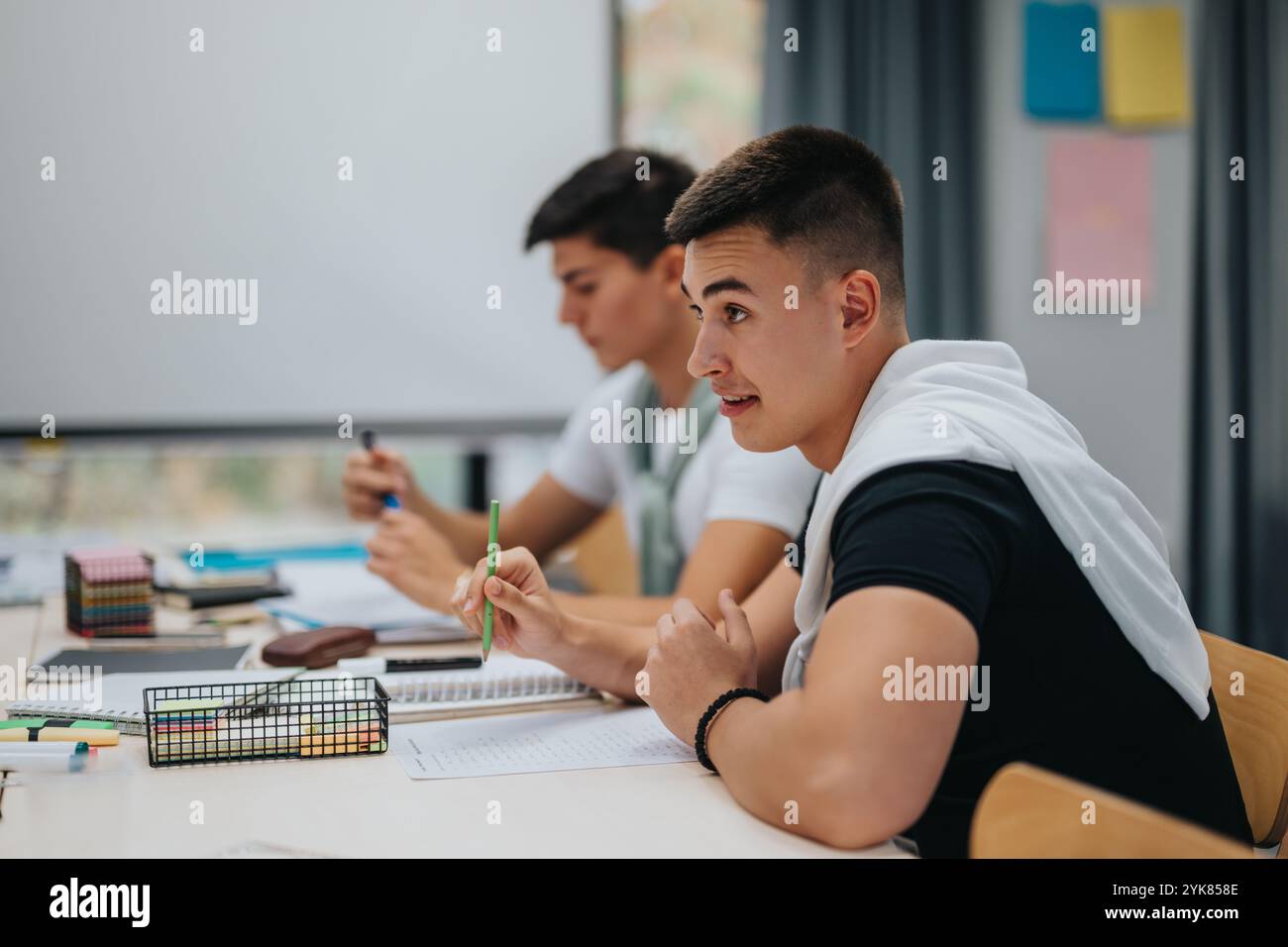 Students in classroom focused on studies and taking notes Stock Photo