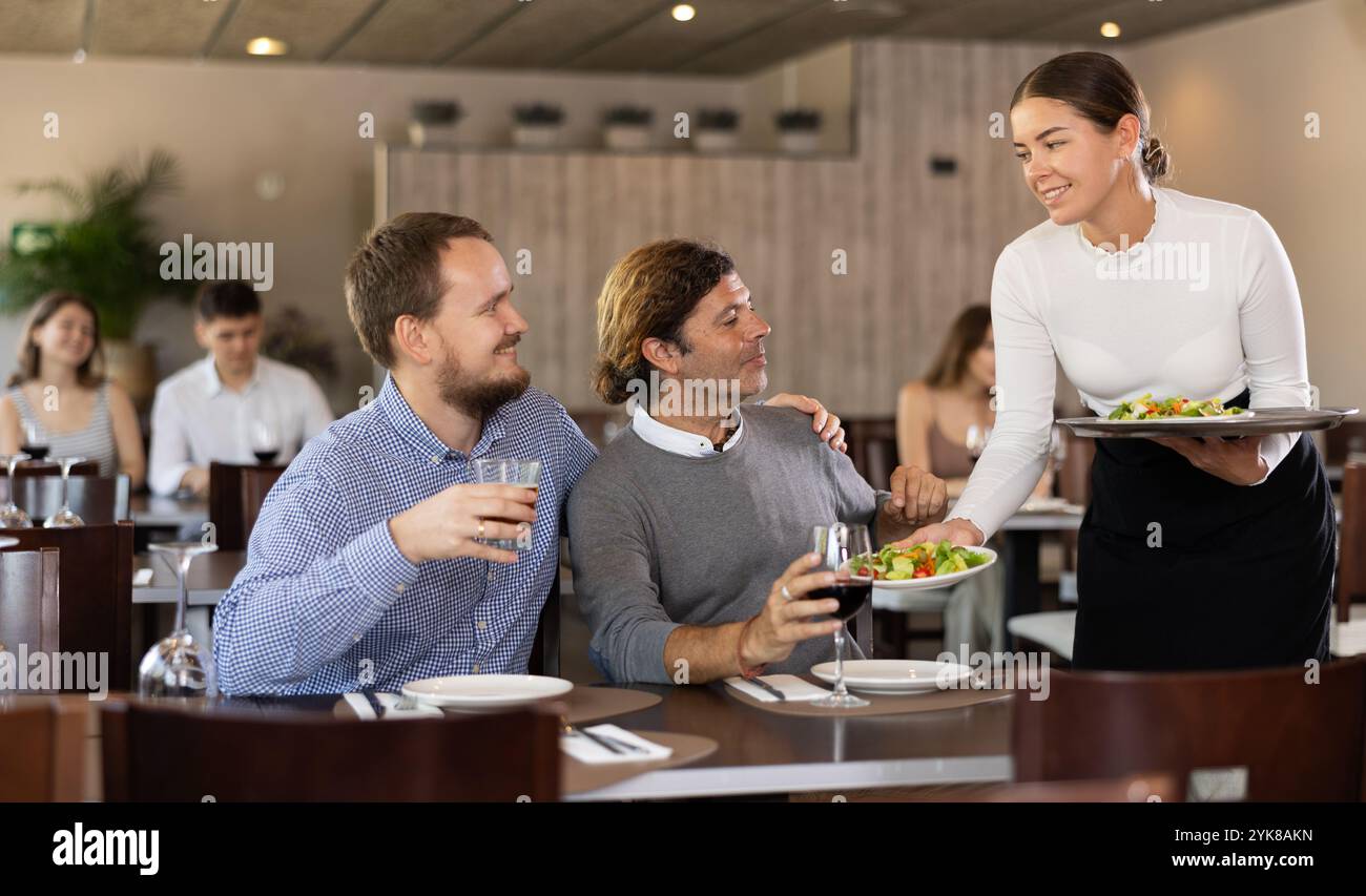 Waitressing Man Young couple takes menu hi-res stock photography and images - Alamy