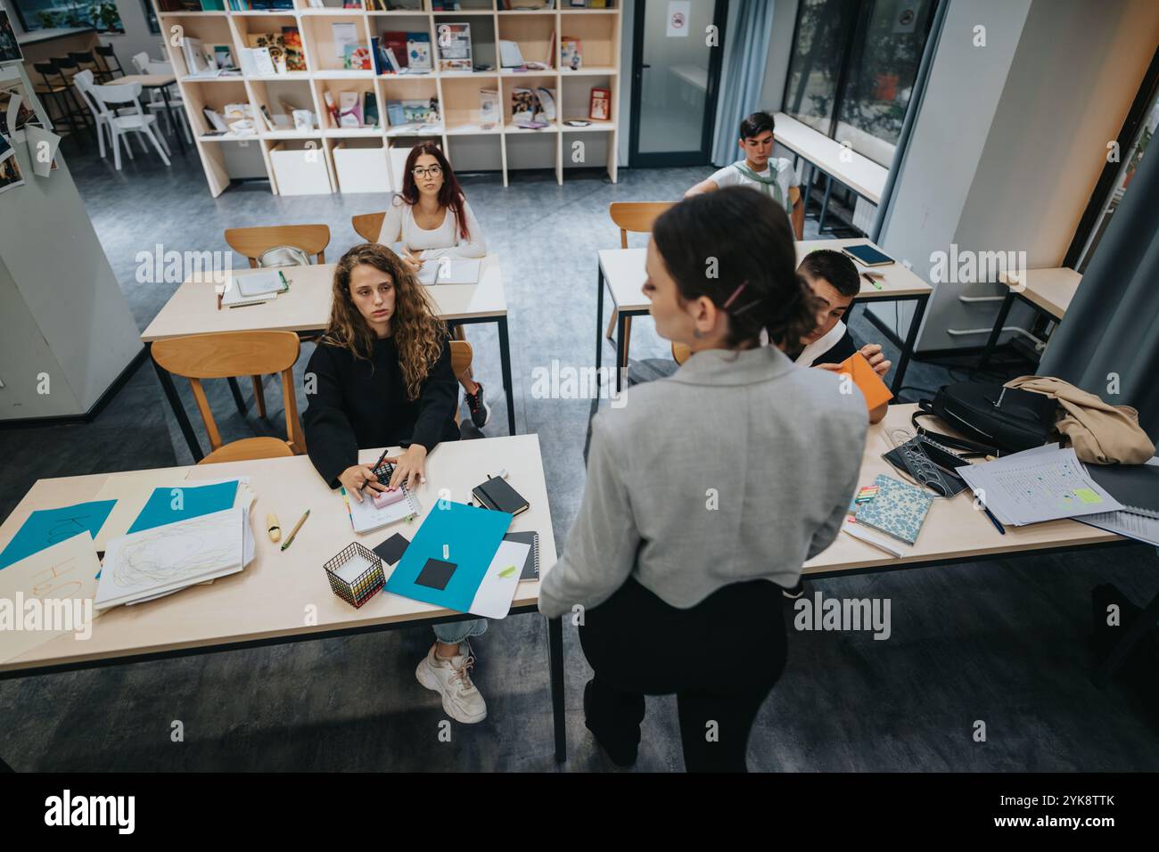 Engaged students learning in a modern classroom environment Stock Photo