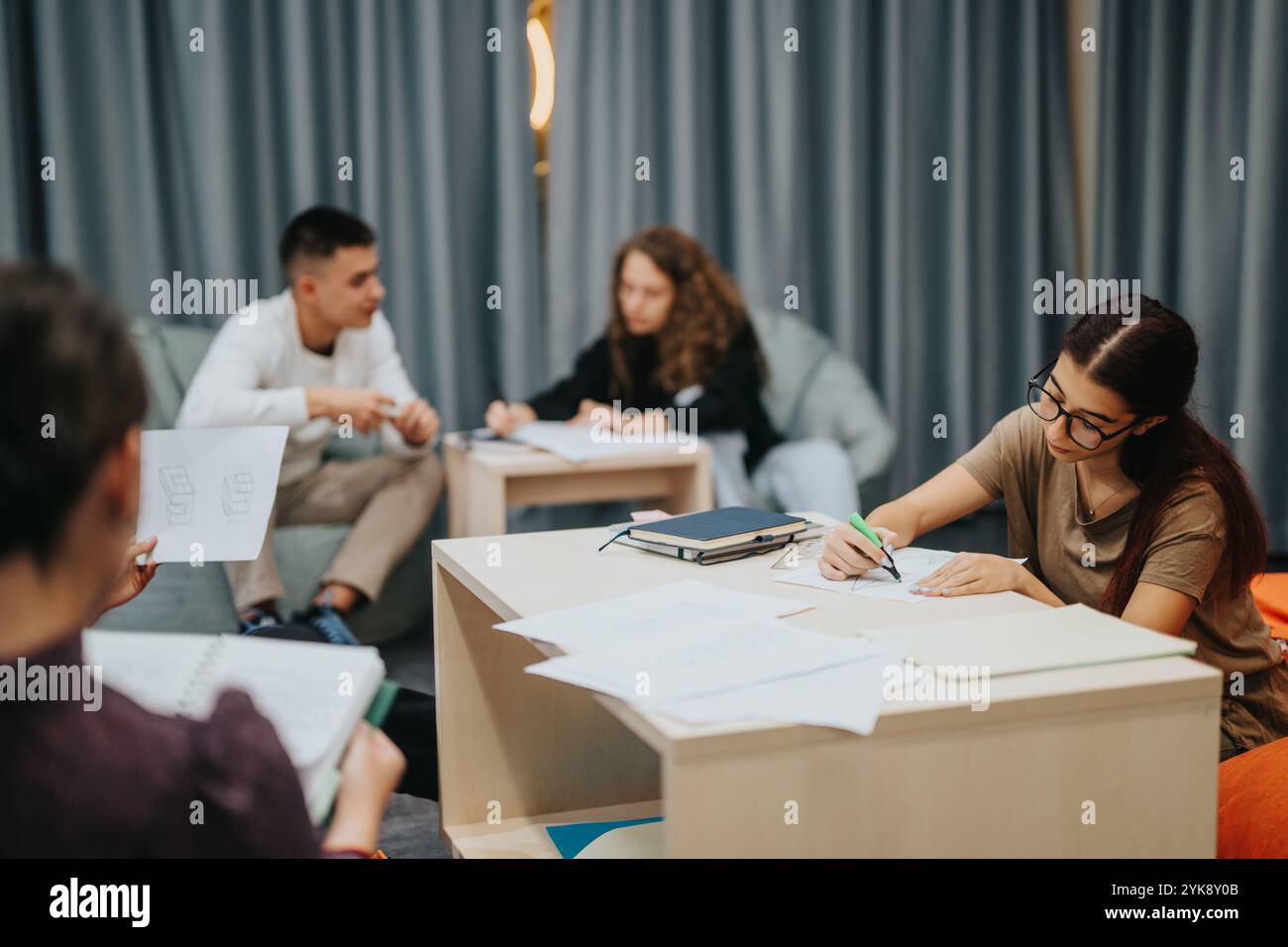 Students engaged in collaborative learning at school, discussing and ...