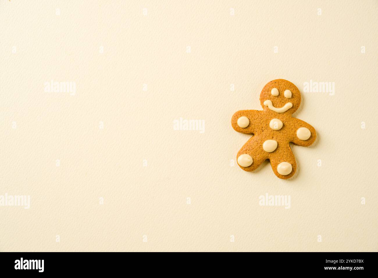 Gingerbread cookie with human shape decoration on yellow background Stock Photo