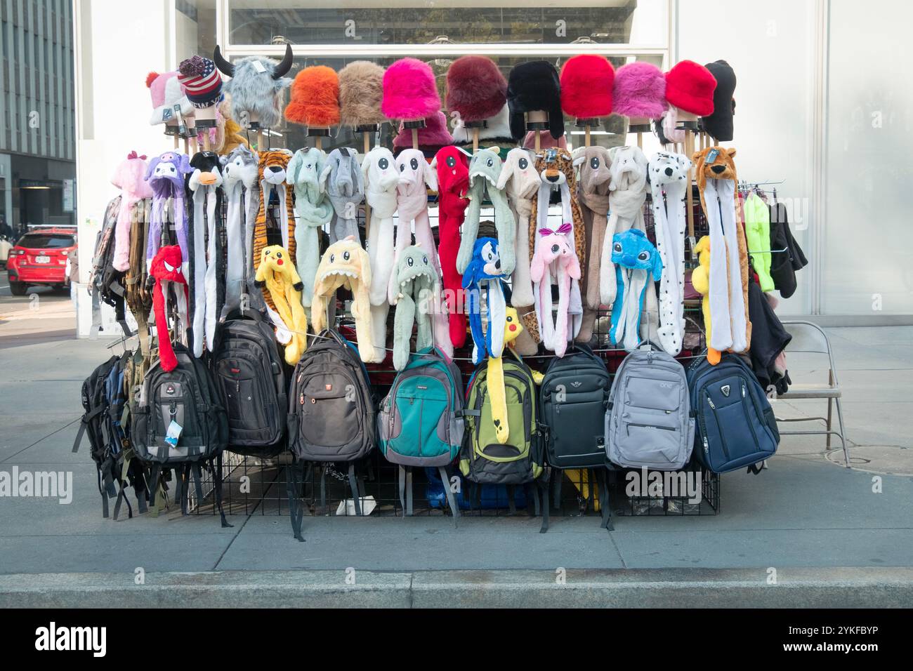 An outdoor stand typically manned by immigrants selling backpacks and winter hats. In Midtown Manhattan, New York City. Stock Photo