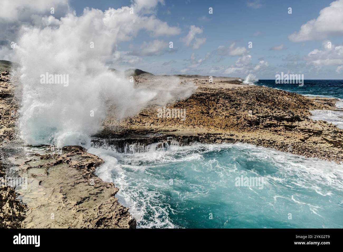 Boka Pistol is a small rocky bay where normal waves create a high fountain of spray with a bang. Weg Zonder Naam, Sabana Westpunt, Curaçao, Kòrsou Stock Photo