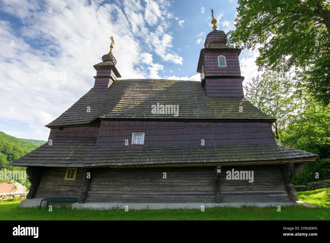 likitsary, transcarpathia, ukraine - jul 02, 2020: st. vasyl wooden church in carpathian mountains. religious sightseeing. sunny summer day. hope in g Stock Photo