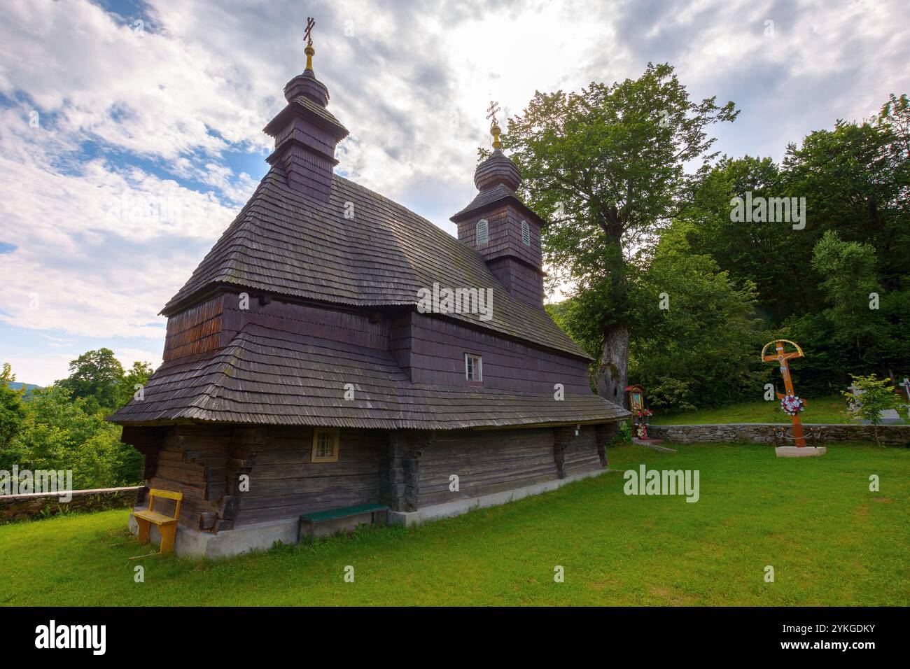 likitsary, transcarpathia, ukraine - jul 02, 2020: st. vasyl wooden church in carpathian mountains. scenic dome. sunny summer day. holy environment Stock Photo