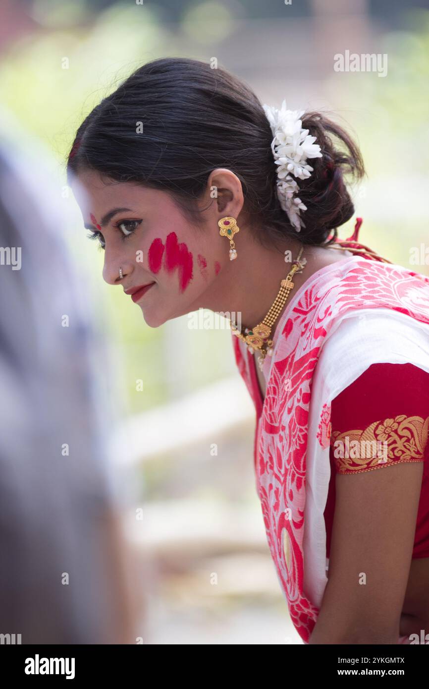 During Sindur Khela, Bengali women dressed in a beautiful traditional saris and jewellery after applying sindoor to goddess' forehead and feet. Stock Photo