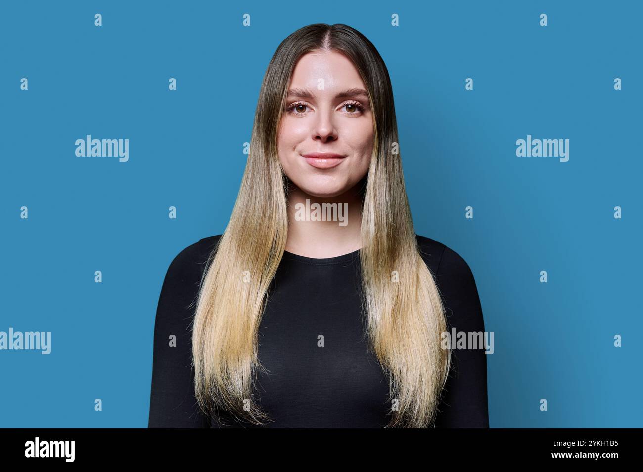 Headshot portrait young smiling woman on blue studio background Stock ...