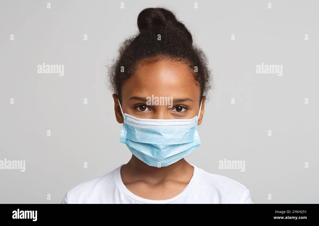 Portrait of little black girl wearing medical mask Stock Photo - Alamy