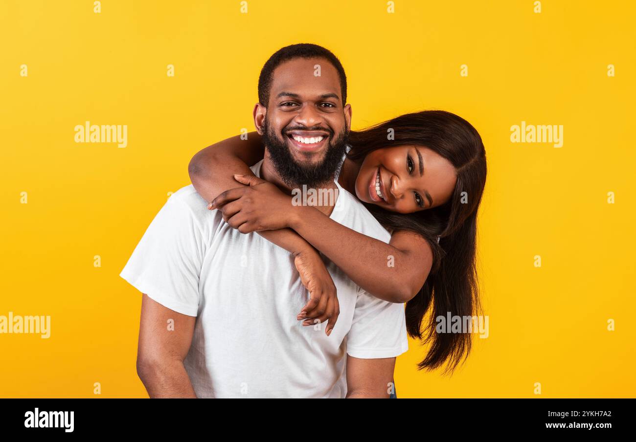 African American woman hugging her man from the back Stock Photo - Alamy