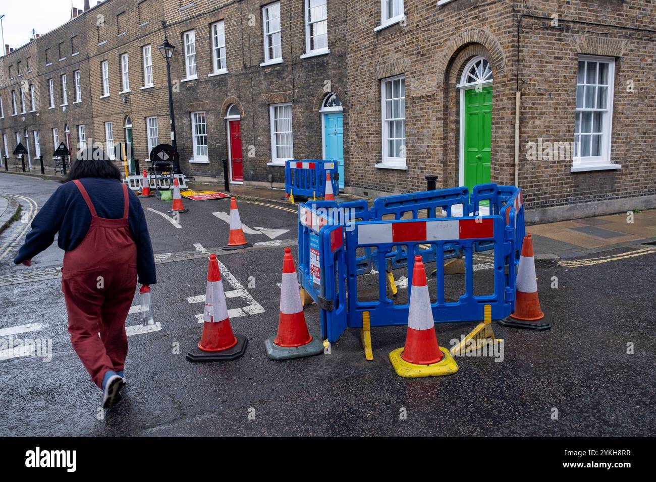 Colourful street works barriers and cones contrast bright front doors ...