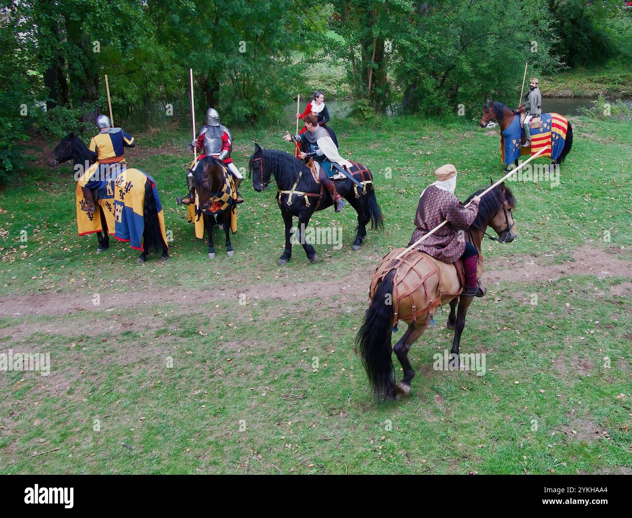 Participants in medieval costumes riding caparisoned horses during a ...