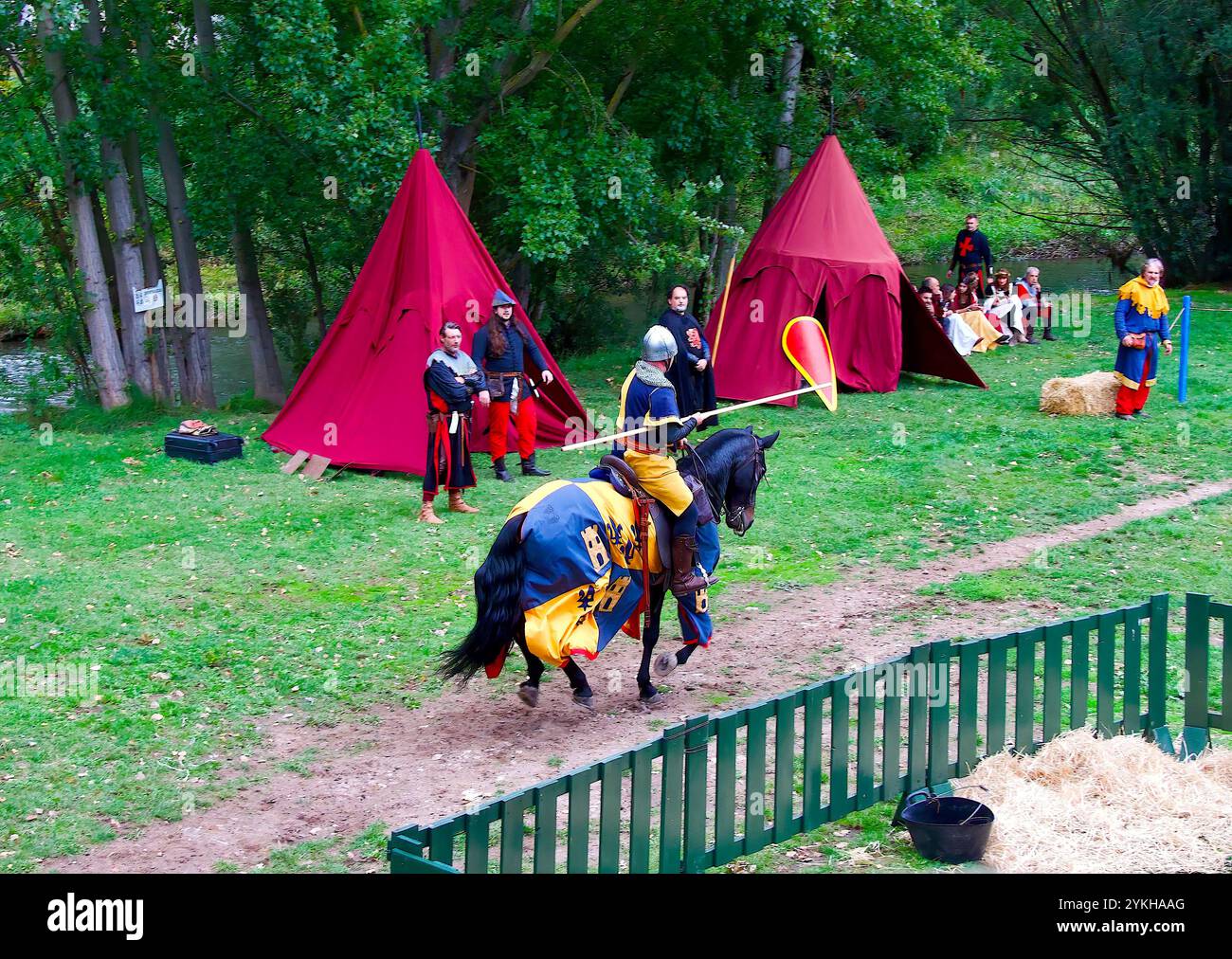 Man in medieval costume rides a caparisoned horse during a historical ...