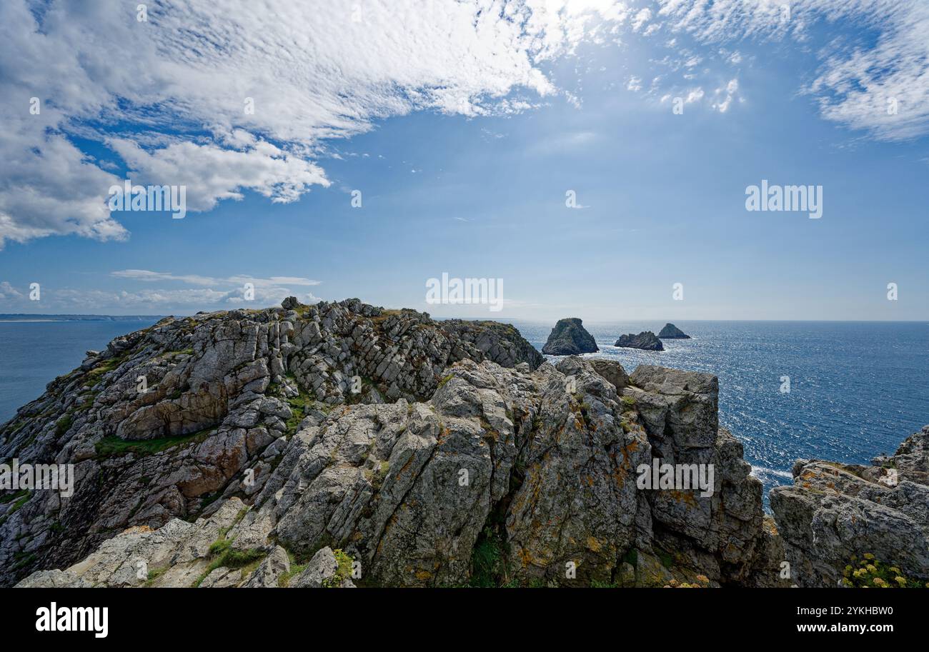 A breathtaking view of rugged coastal cliffs under a bright, clear blue sky. Stock Photo