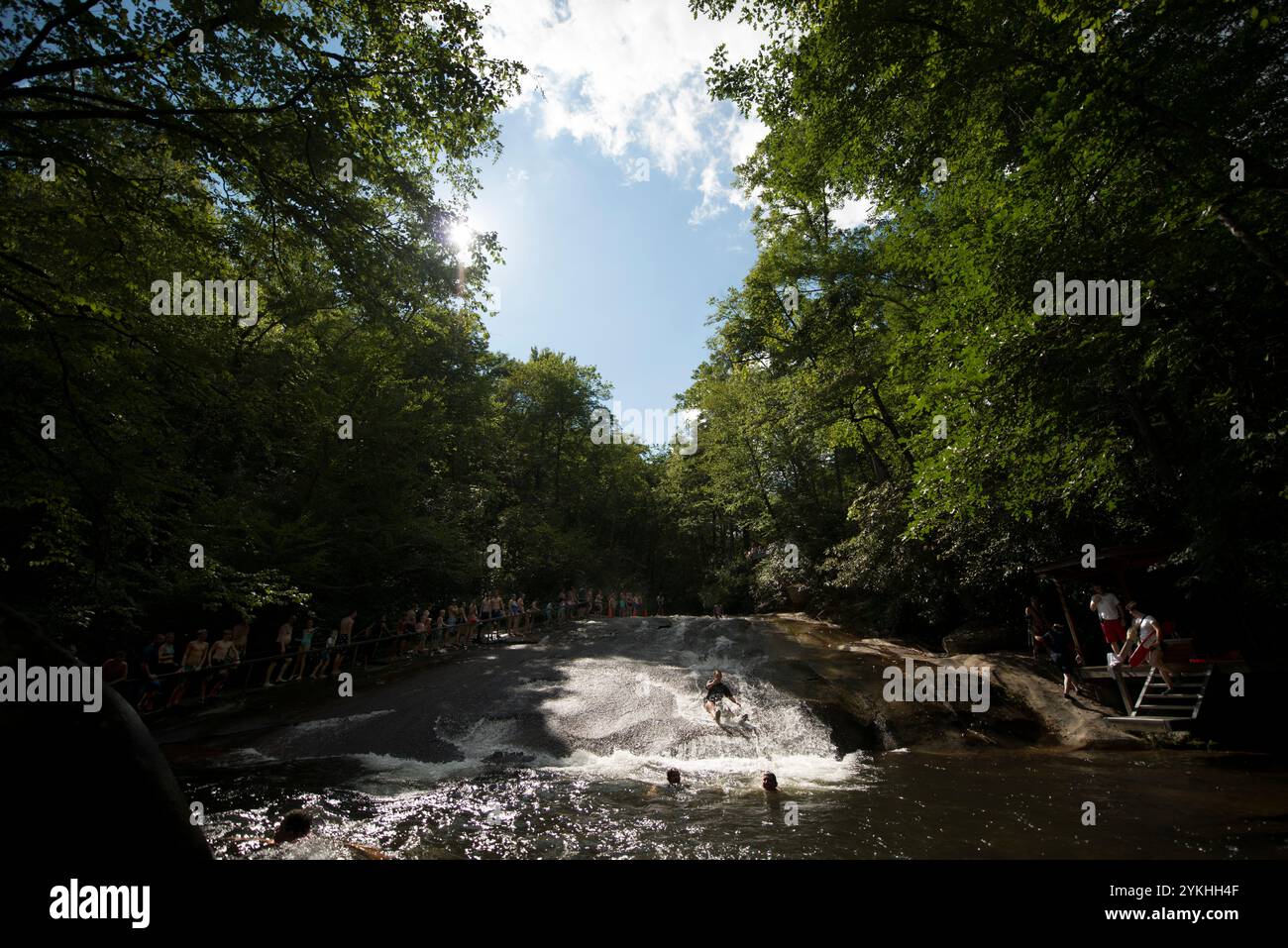 People take turns sliding down the Sliding Rock in Pisgah National ...