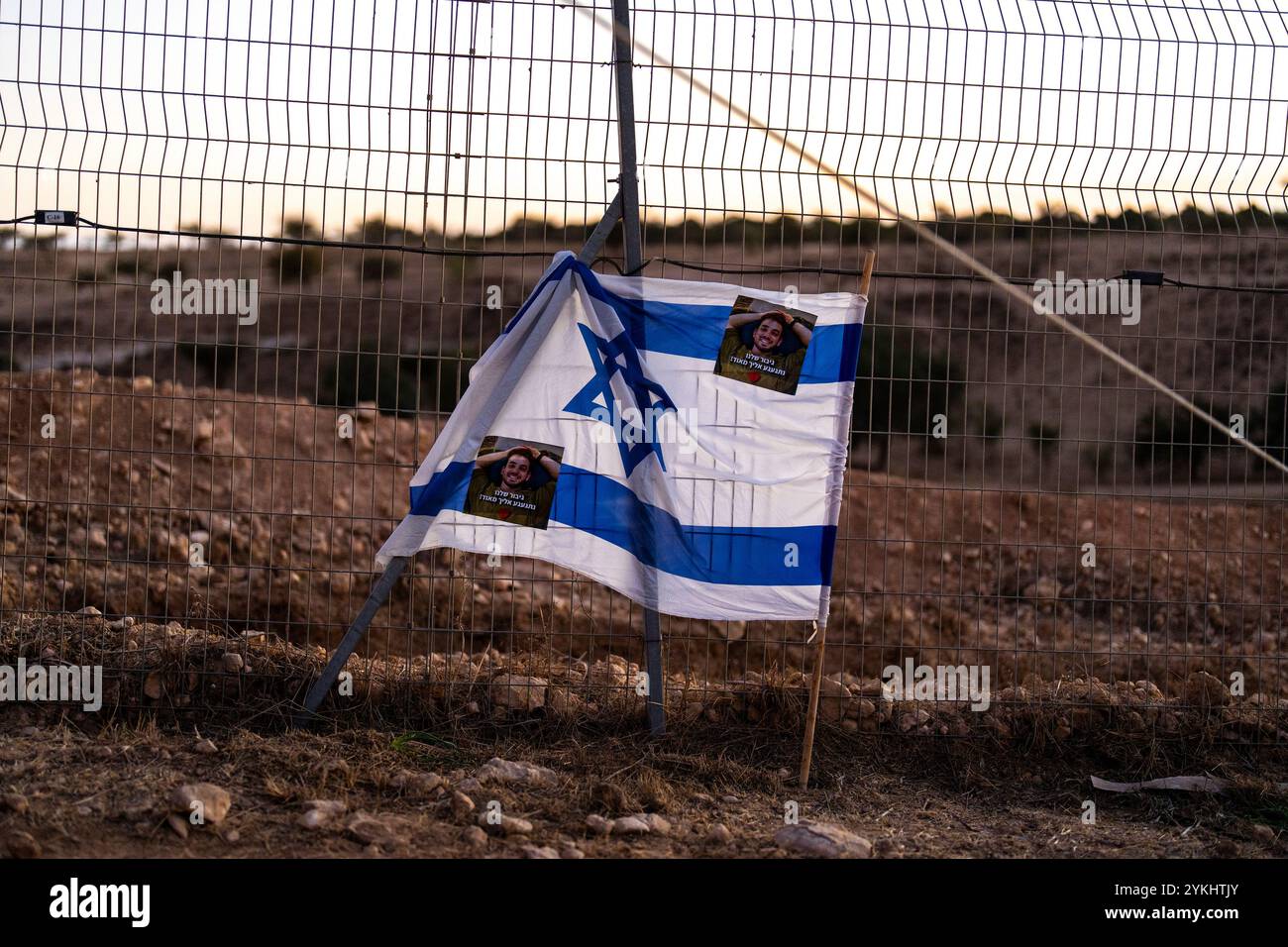 an-israeli-flag-with-photographs-of-captain-yogev-pazi-who-was-killed