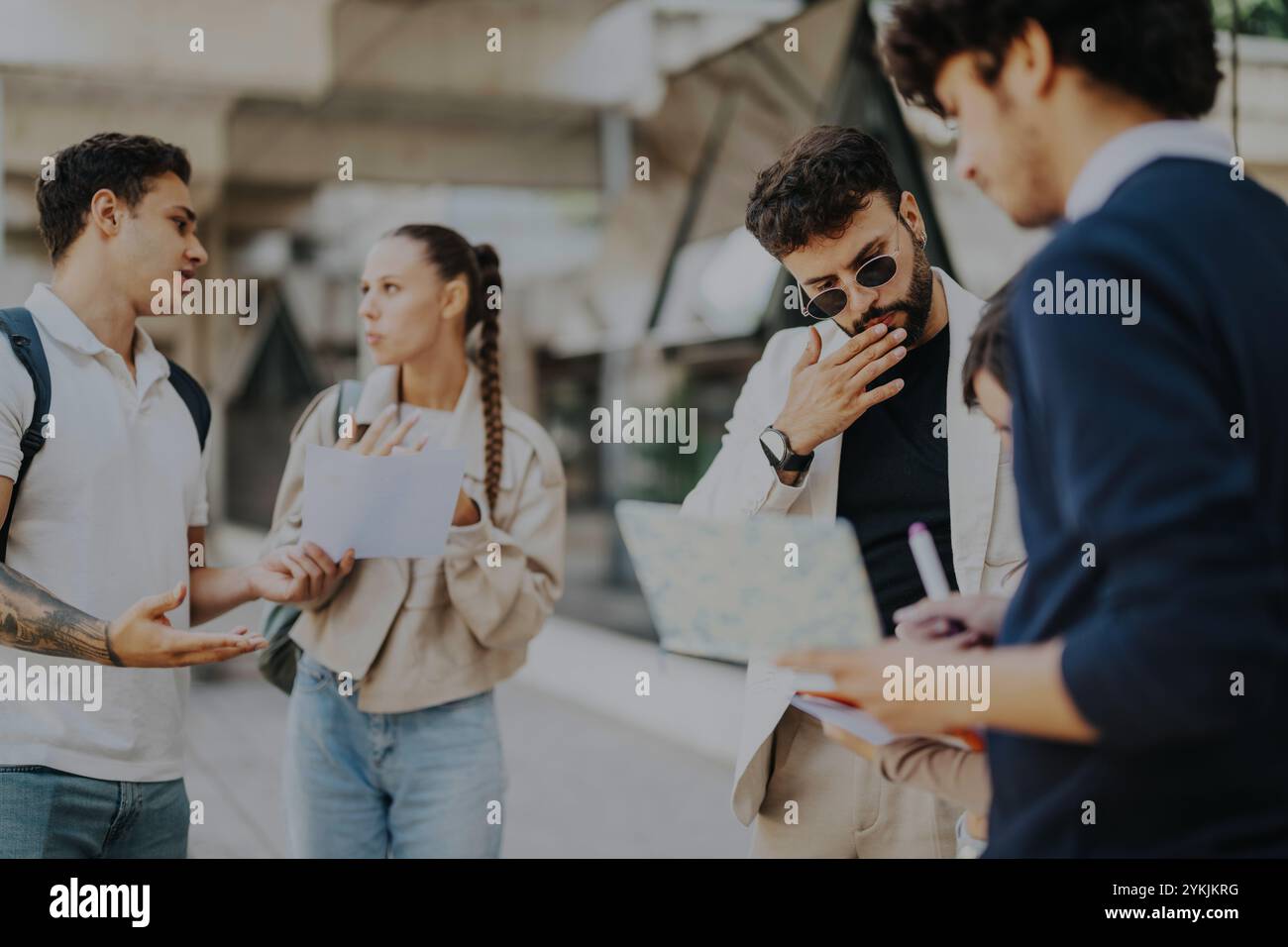 Students engaged in outdoor discussion with their professor Stock Photo