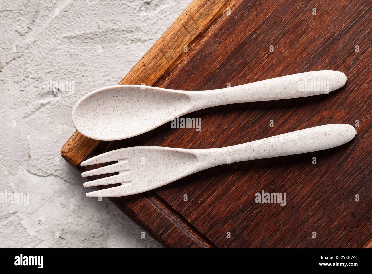 Rustic Plastic Spoon A recycled plastic spoon and fork is seen on rustic wood Stock Photo ...
