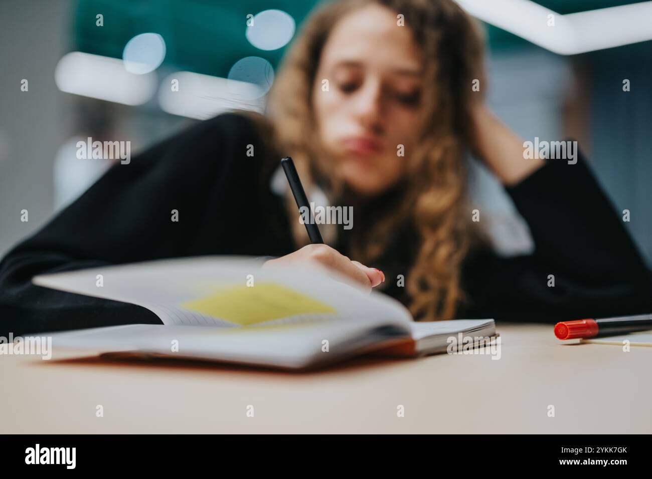 Focused Student Writing High school student focused on writing in classroom setting Stock Photo ...
