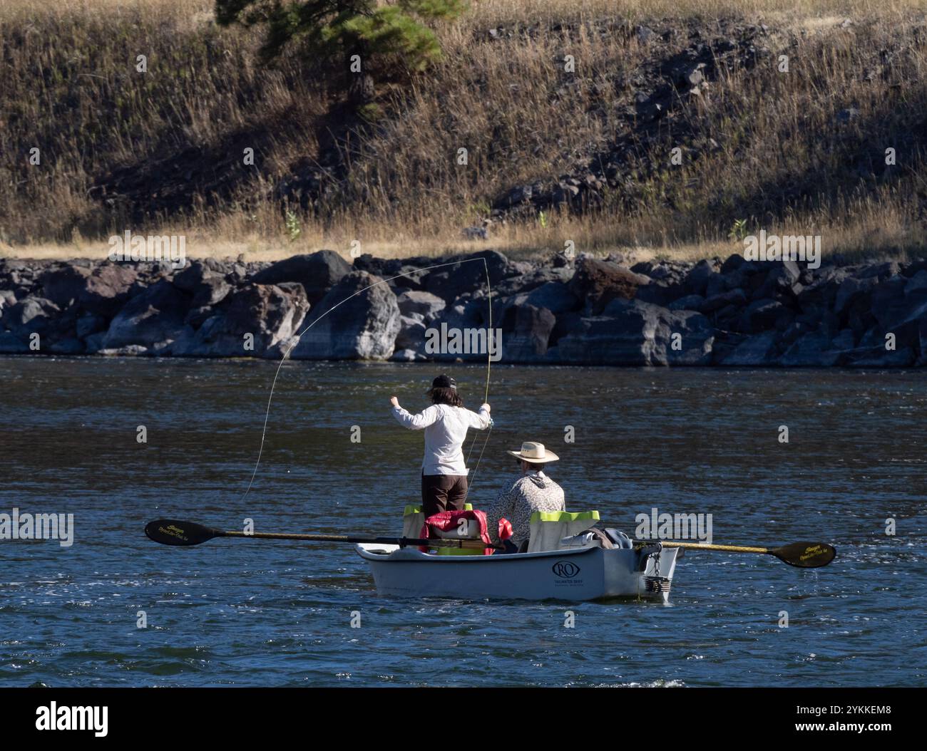 Woman fly fishing in the Missouri River in Montana while standing in a ...