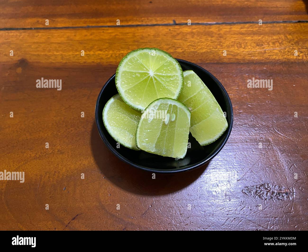 Lime slices served in a bowl to add freshness to foods such as soto and others. Stock Photo
