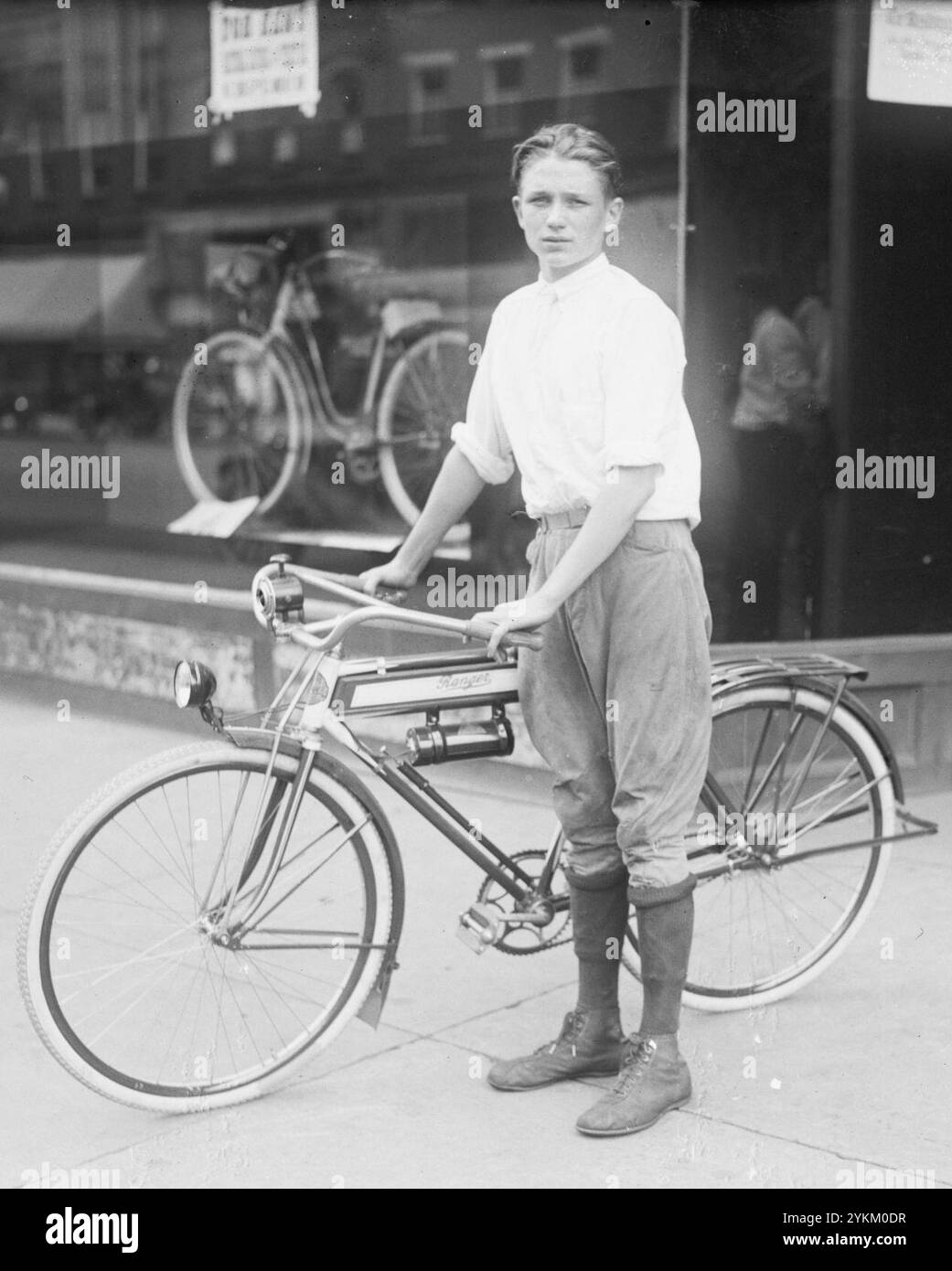 Boy with a Ranger brand bicycle in 1921, from- T(...) boy on bicycle Stock Photo