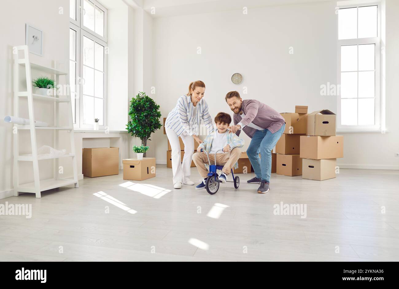 Happy Family Celebrating Move To New Home Stock Photo - Alamy