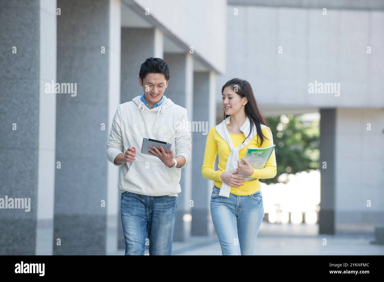 University student couple walking on campus Stock Photo - Alamy