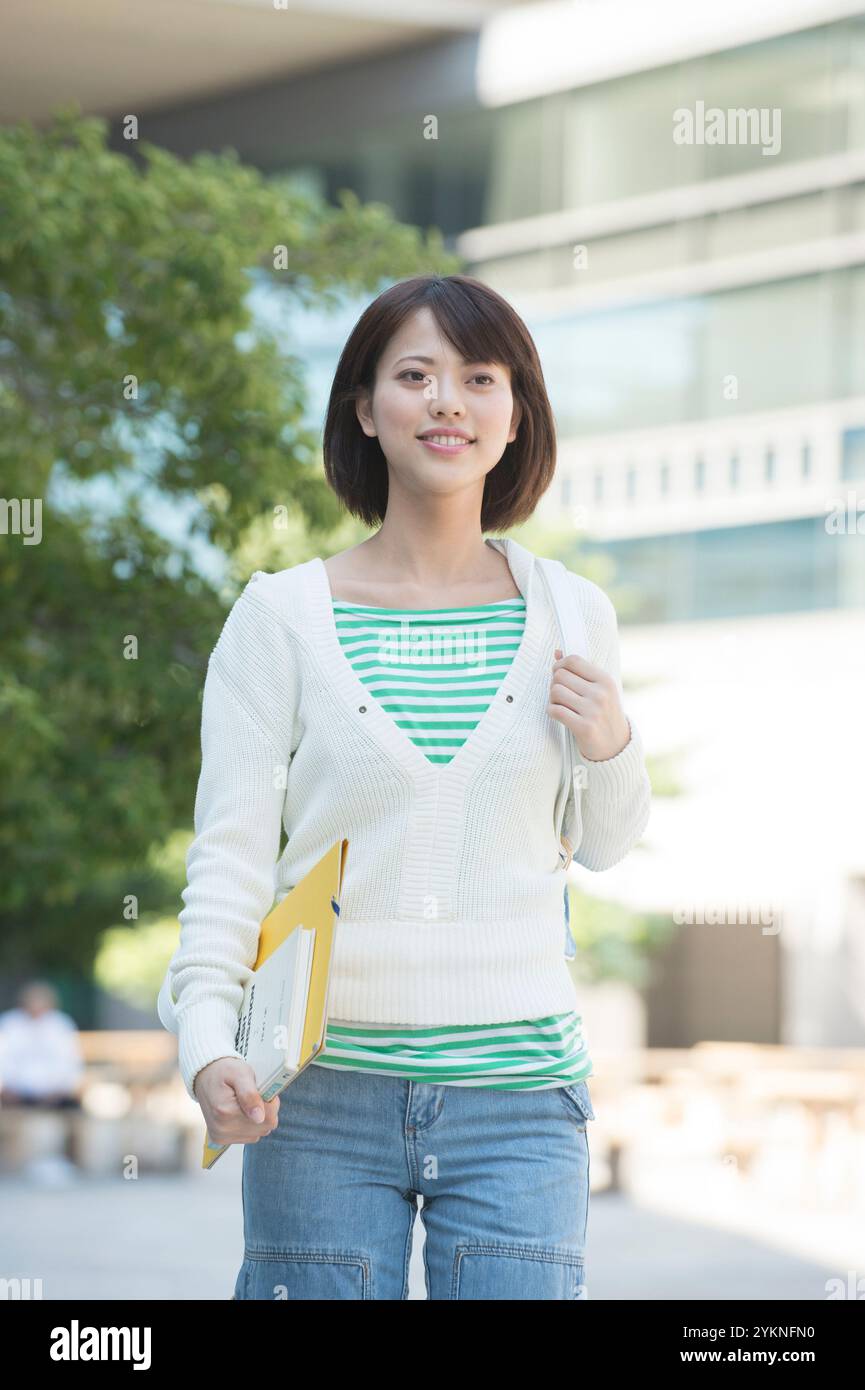 Female university students walking on campus Stock Photo - Alamy