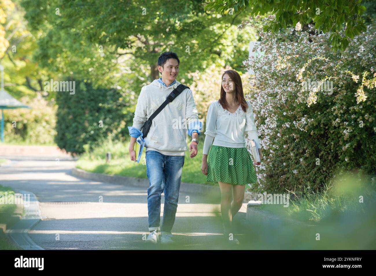 University student couple walking on campus Stock Photo - Alamy