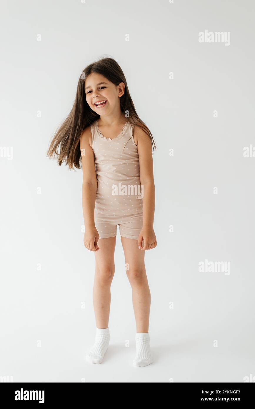 Cute girl wearing pajamas on white background Stock Photo - Alamy
