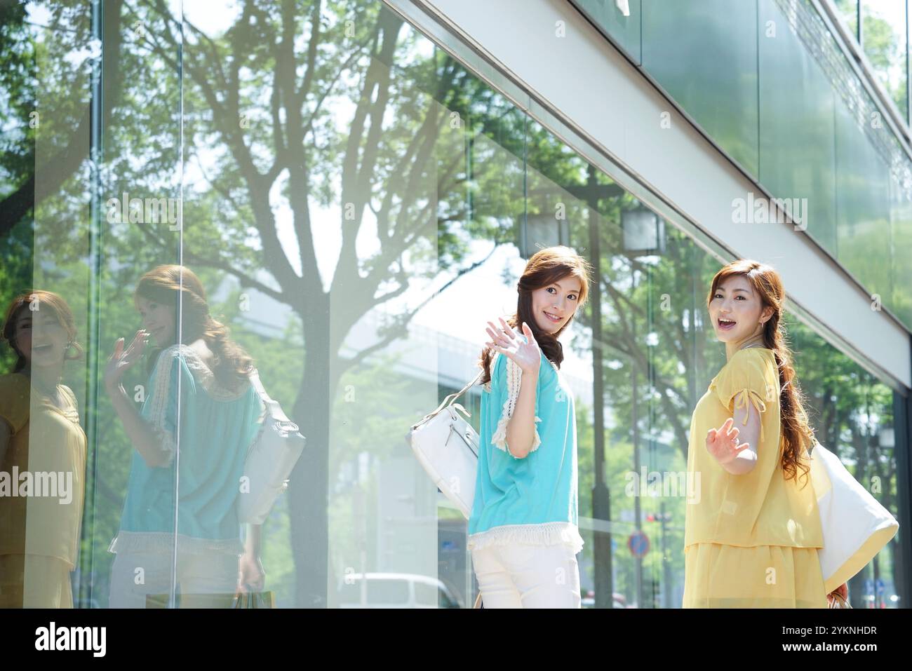 Two young women walking hand in hand hi-res stock photography and ...