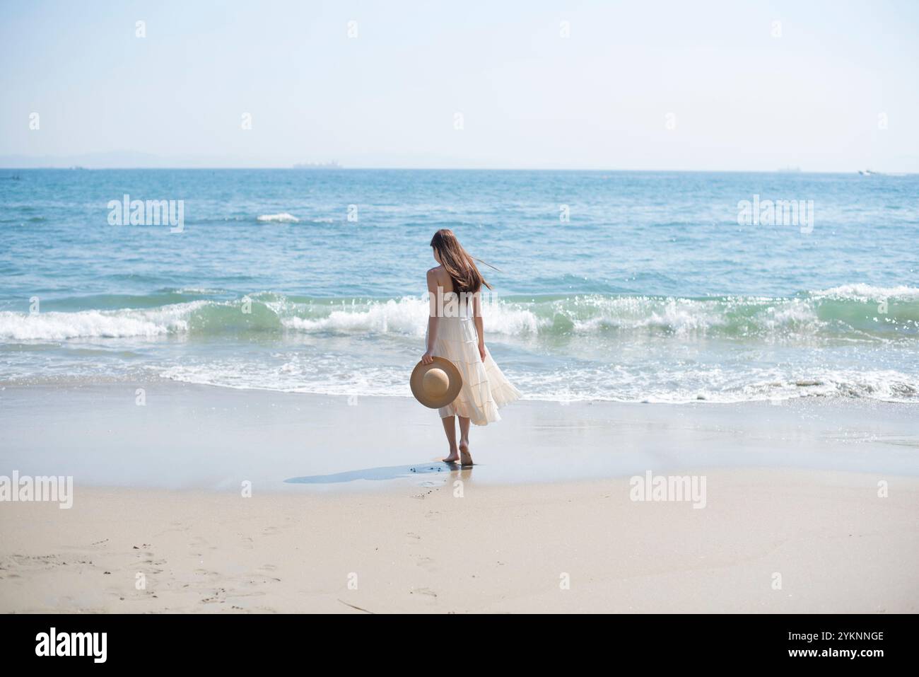 Woman walking barefoot on sea sand beach Stock Photo - Alamy
