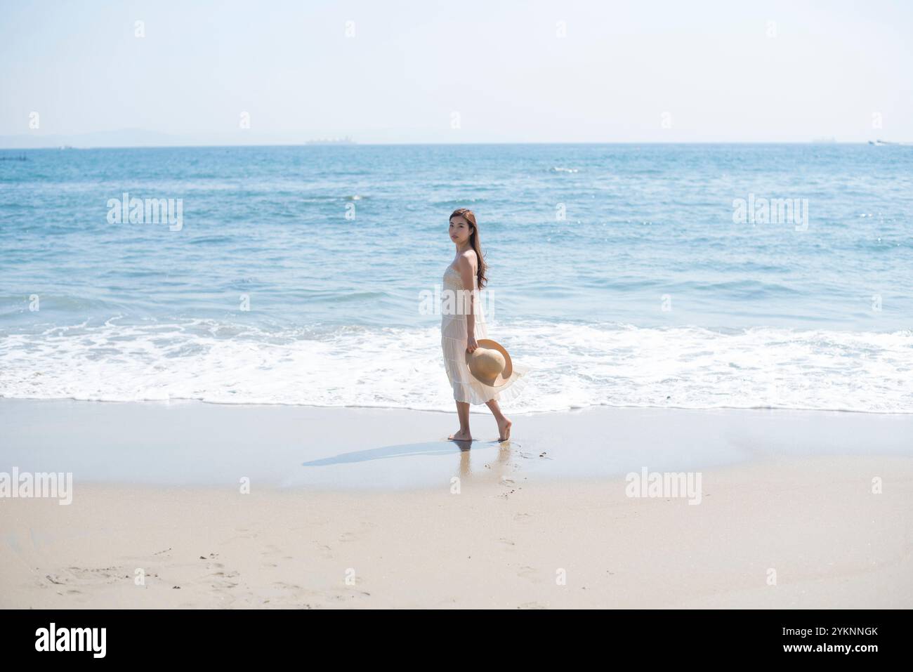 Woman walking barefoot on sea sand beach Stock Photo - Alamy