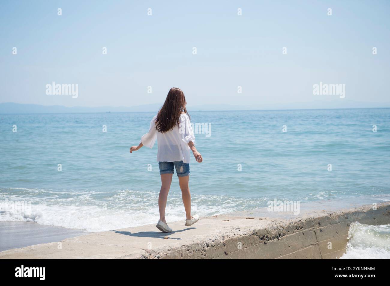 Back view woman walking sea hi-res stock photography and images - Alamy