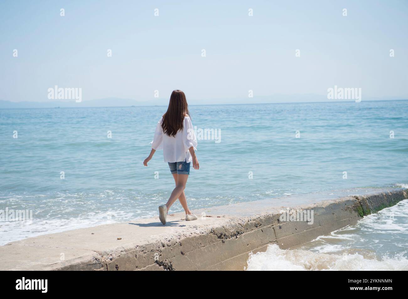 Back view woman walking sea hi-res stock photography and images - Alamy