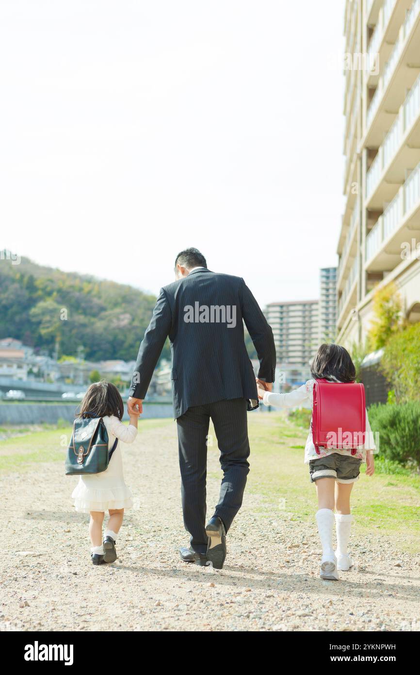 Father and daughter walking hand in hand Stock Photo - Alamy