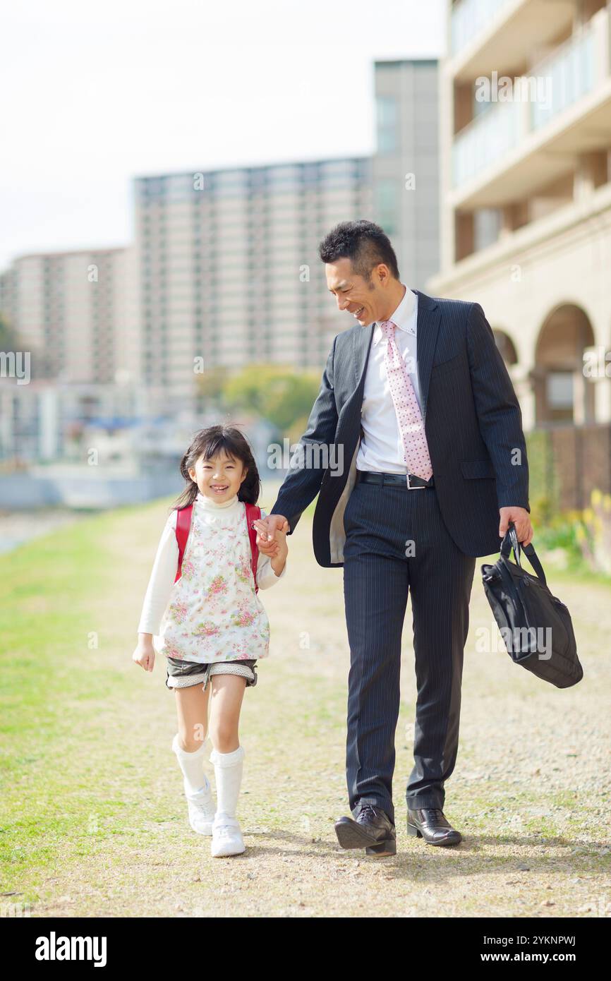 Father and daughter walking hand in hand Stock Photo - Alamy