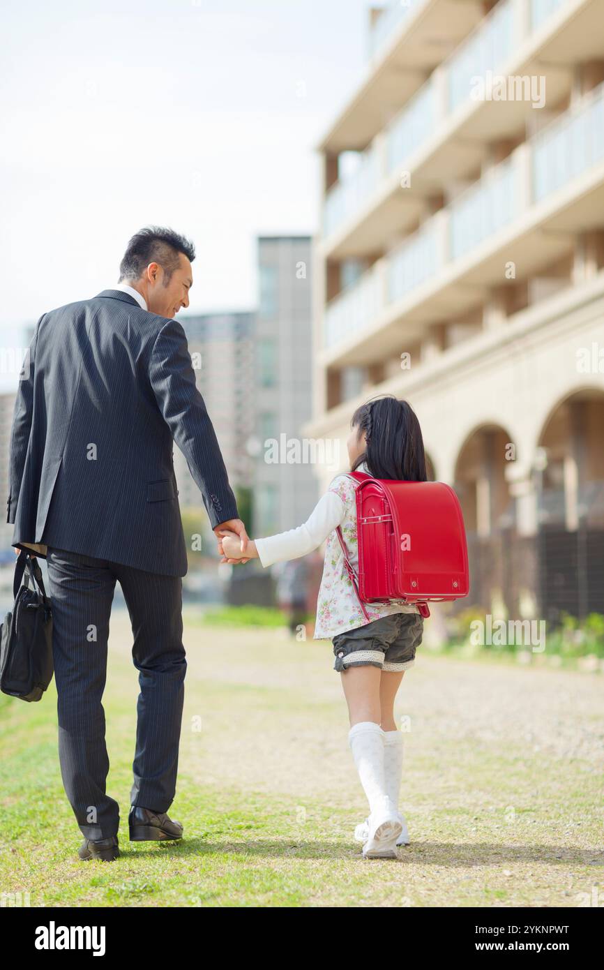 Father and daughter walking hand in hand Stock Photo - Alamy