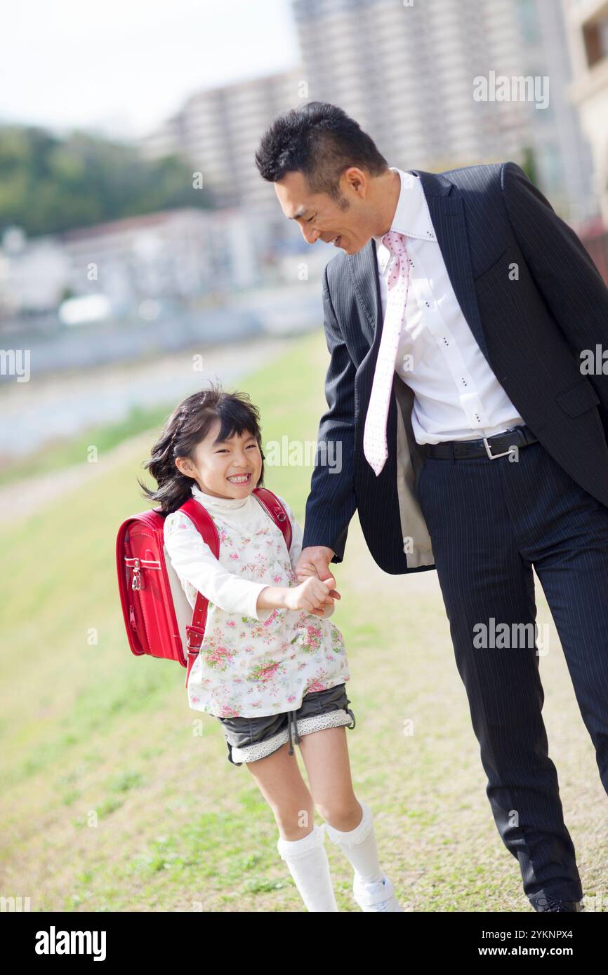 Father and daughter walking hand in hand Stock Photo - Alamy