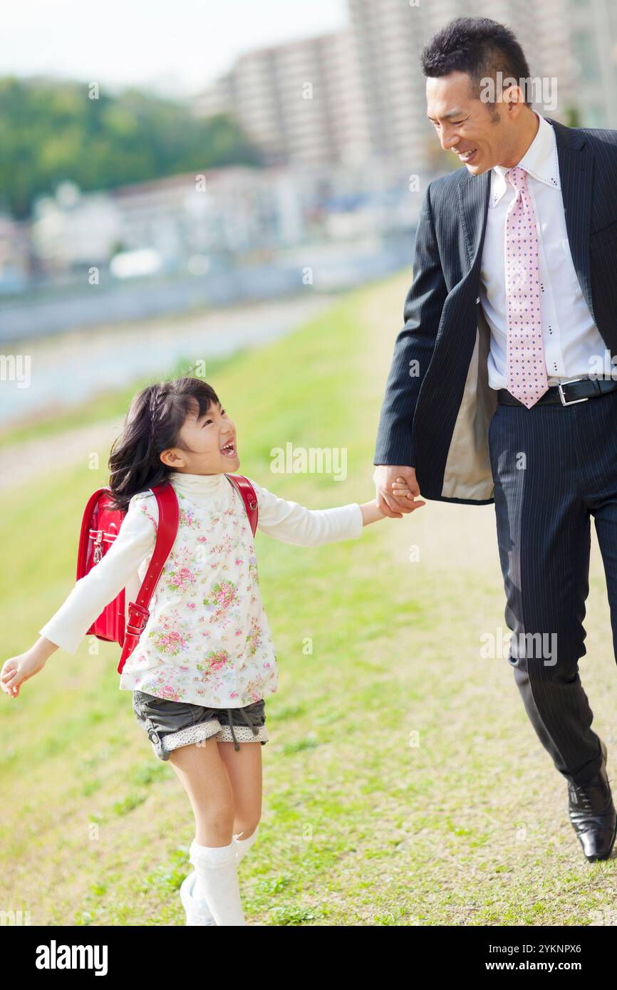 Father and daughter walking hand in hand Stock Photo - Alamy