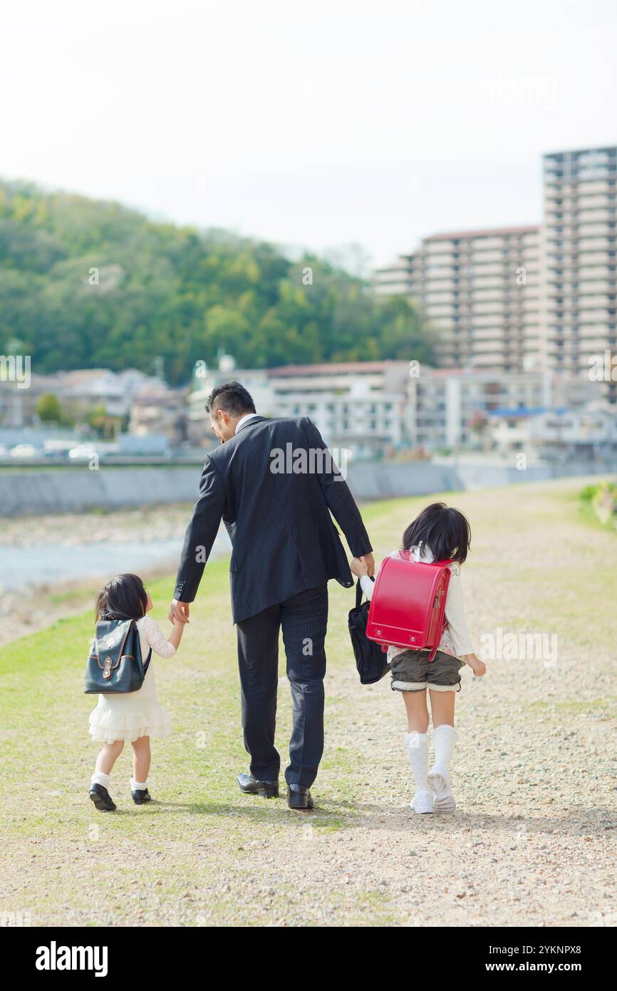 Father and daughter walking hand in hand Stock Photo - Alamy