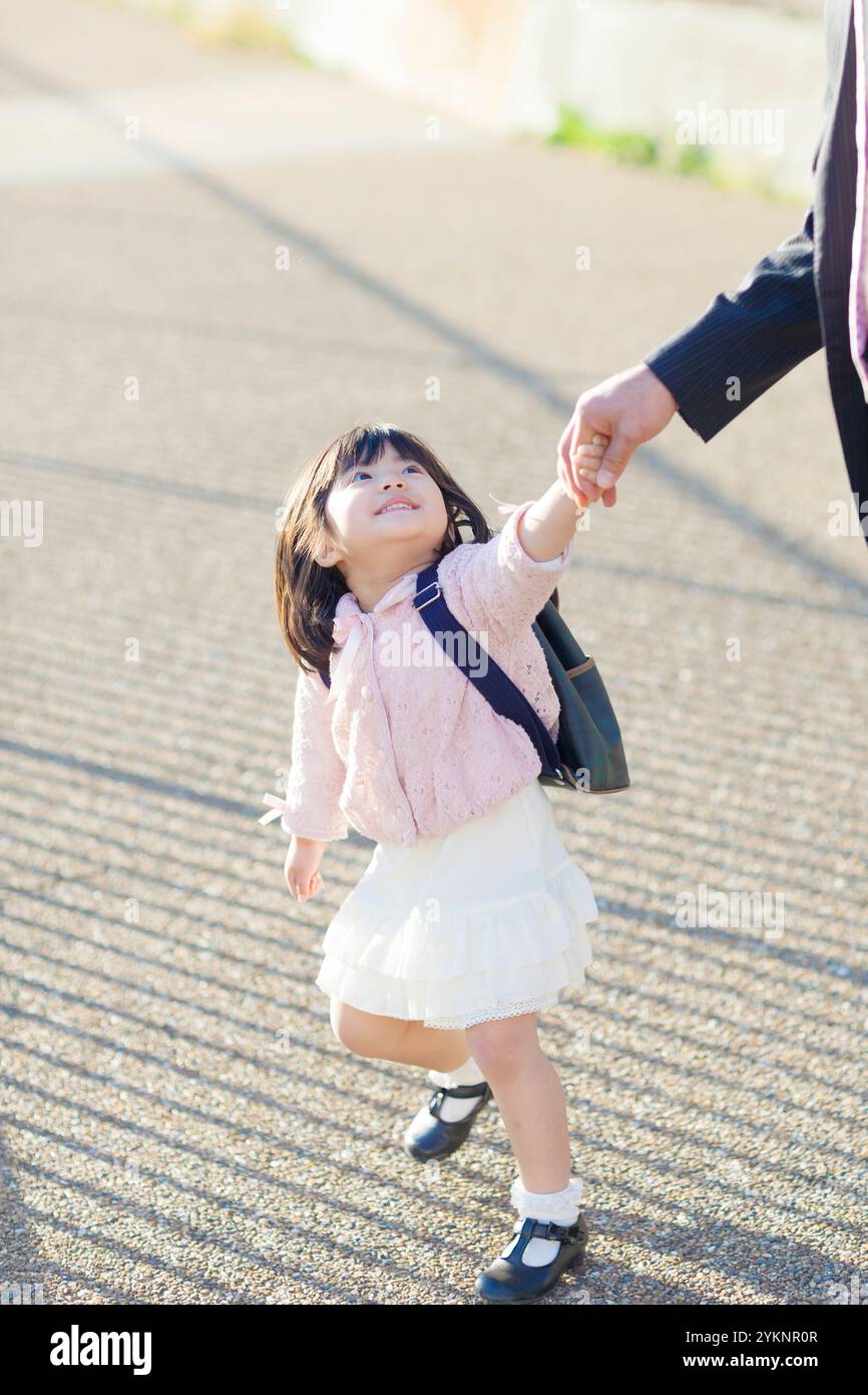 Kindergarten girl walking hand in hand with her father Stock Photo - Alamy