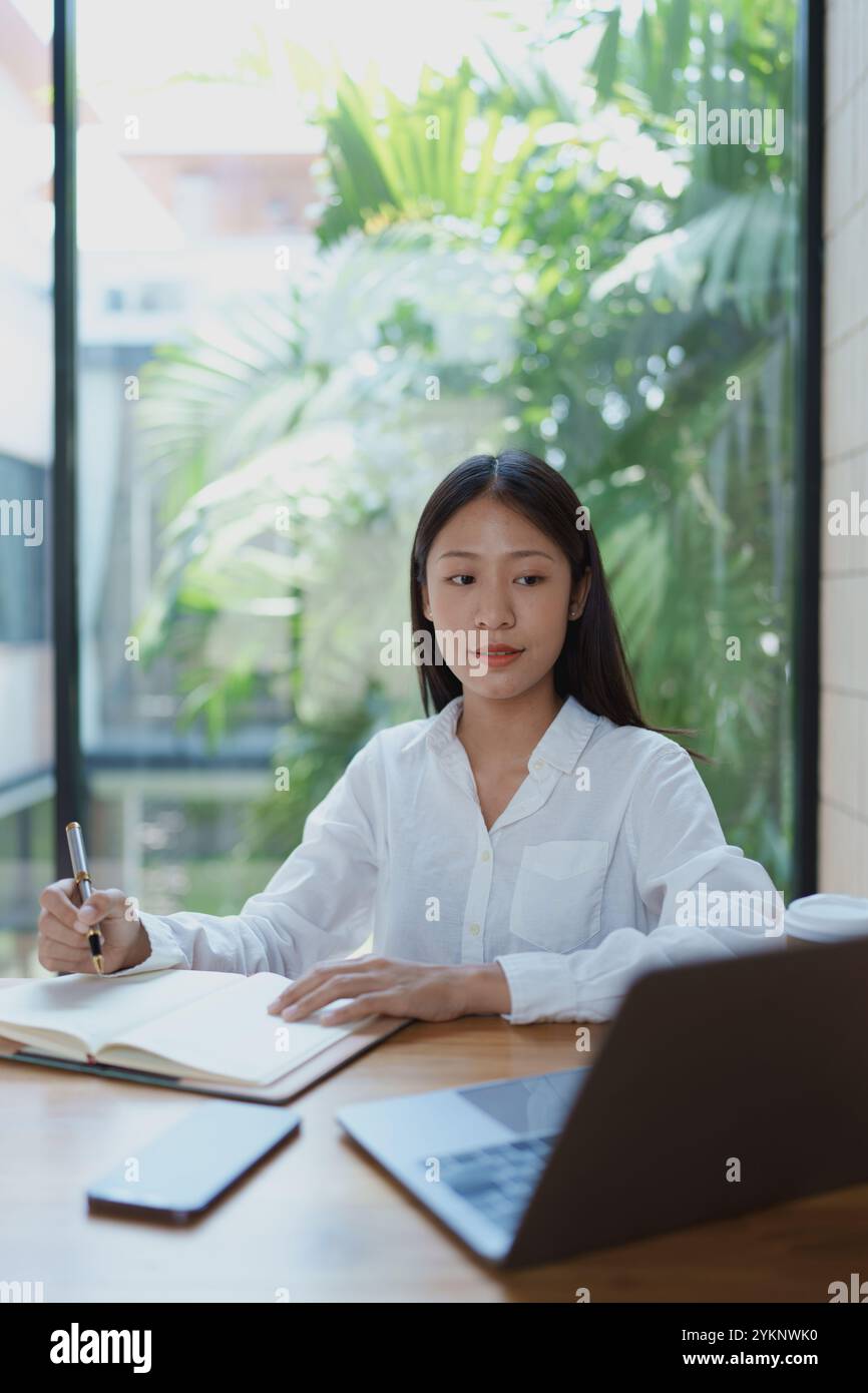 Woman thinking in office environment hi-res stock photography and ...