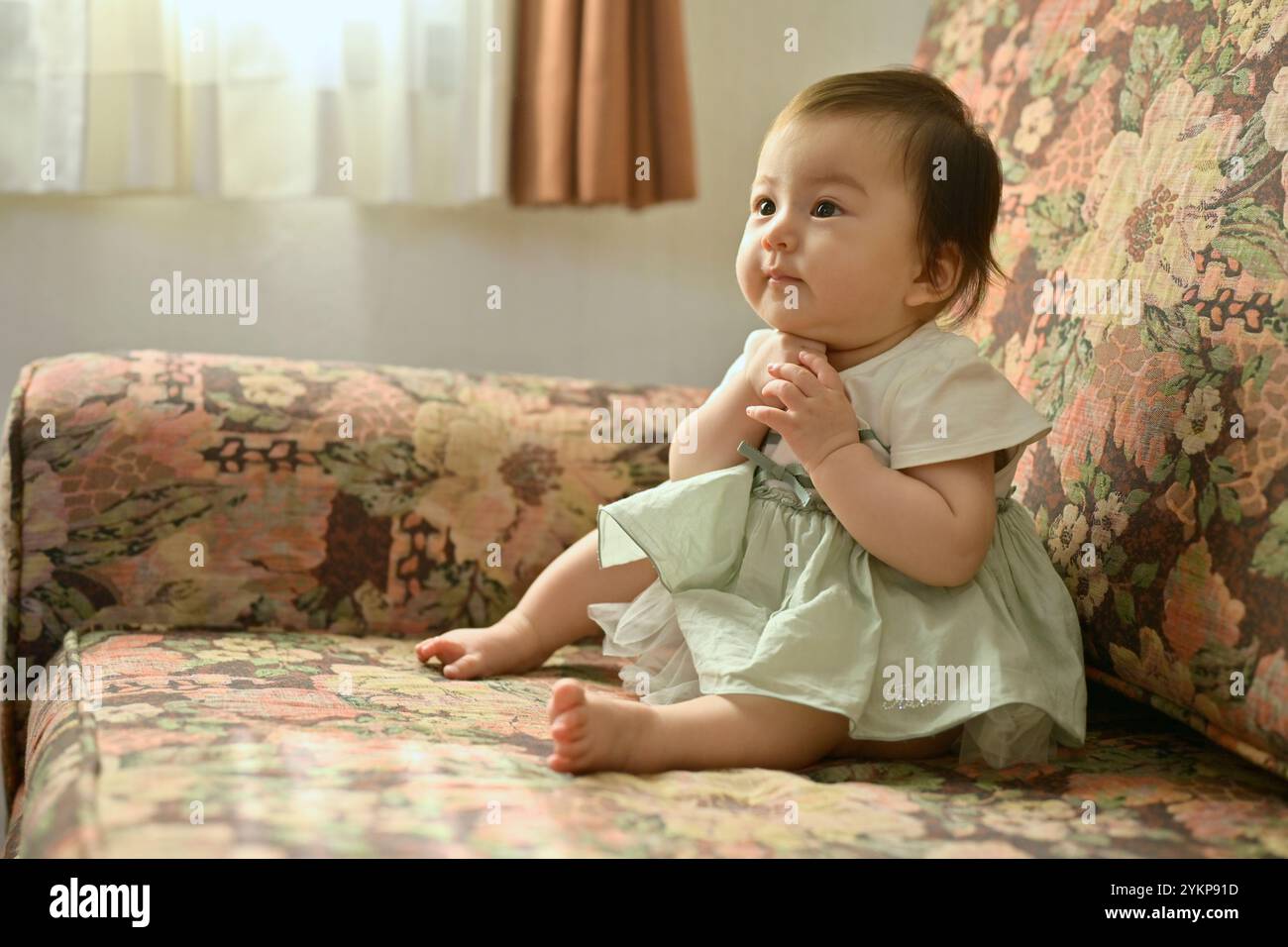Girl sitting barefoot on sofa hi-res stock photography and images - Alamy