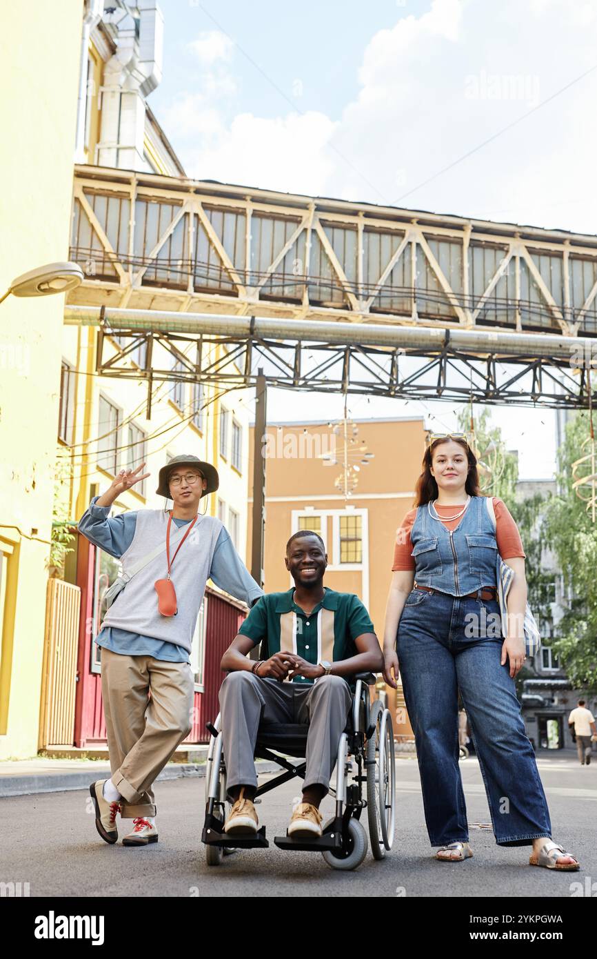 Vertical full length portrait of inclusive group of friends with ...