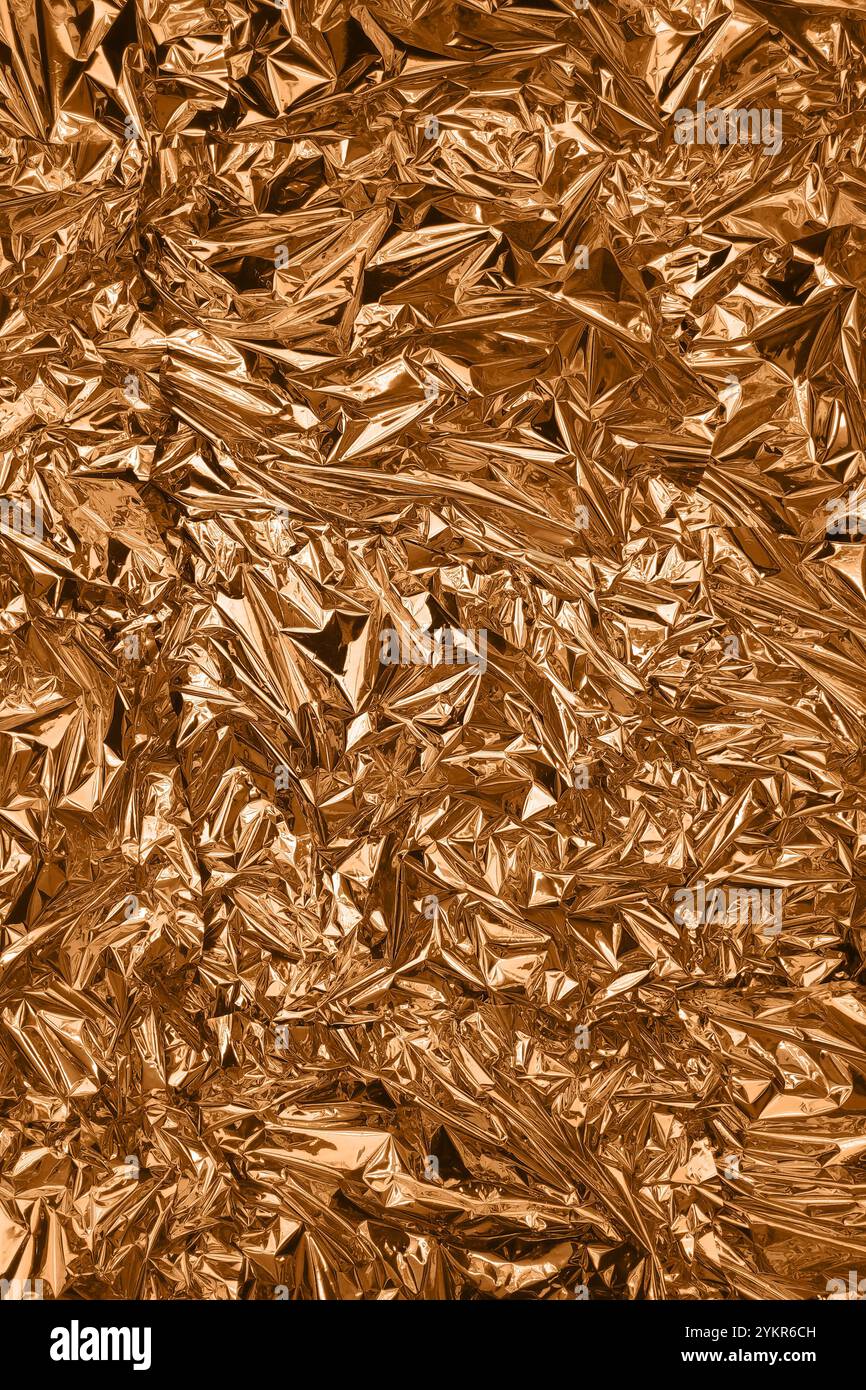 Fullframe crumpled copper foil shining texture background. Stock Photo