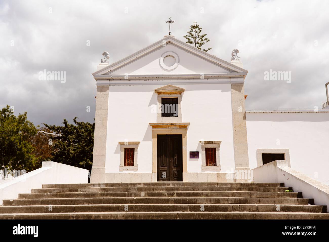 Small Chapel with cloudy sky in the background - Albufeira, Algarve - Portugal Stock Photo