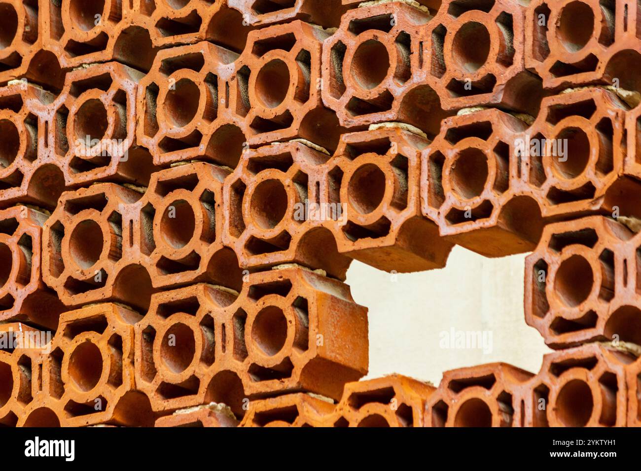 Abstract Pattern of Orange Clay Bricks with Circle Cutouts Stock Photo