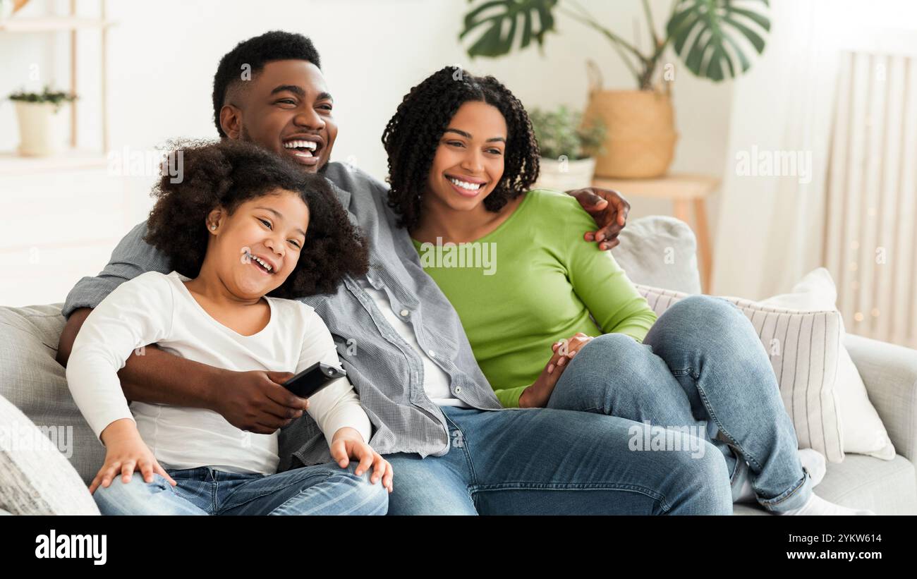 Happy black family relaxing and at home, watching tv together Stock ...